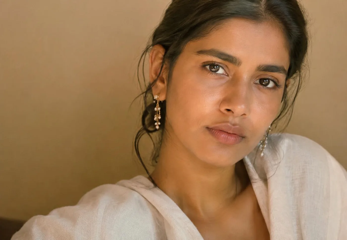 Pearl earrings worn in warm Jaipur light