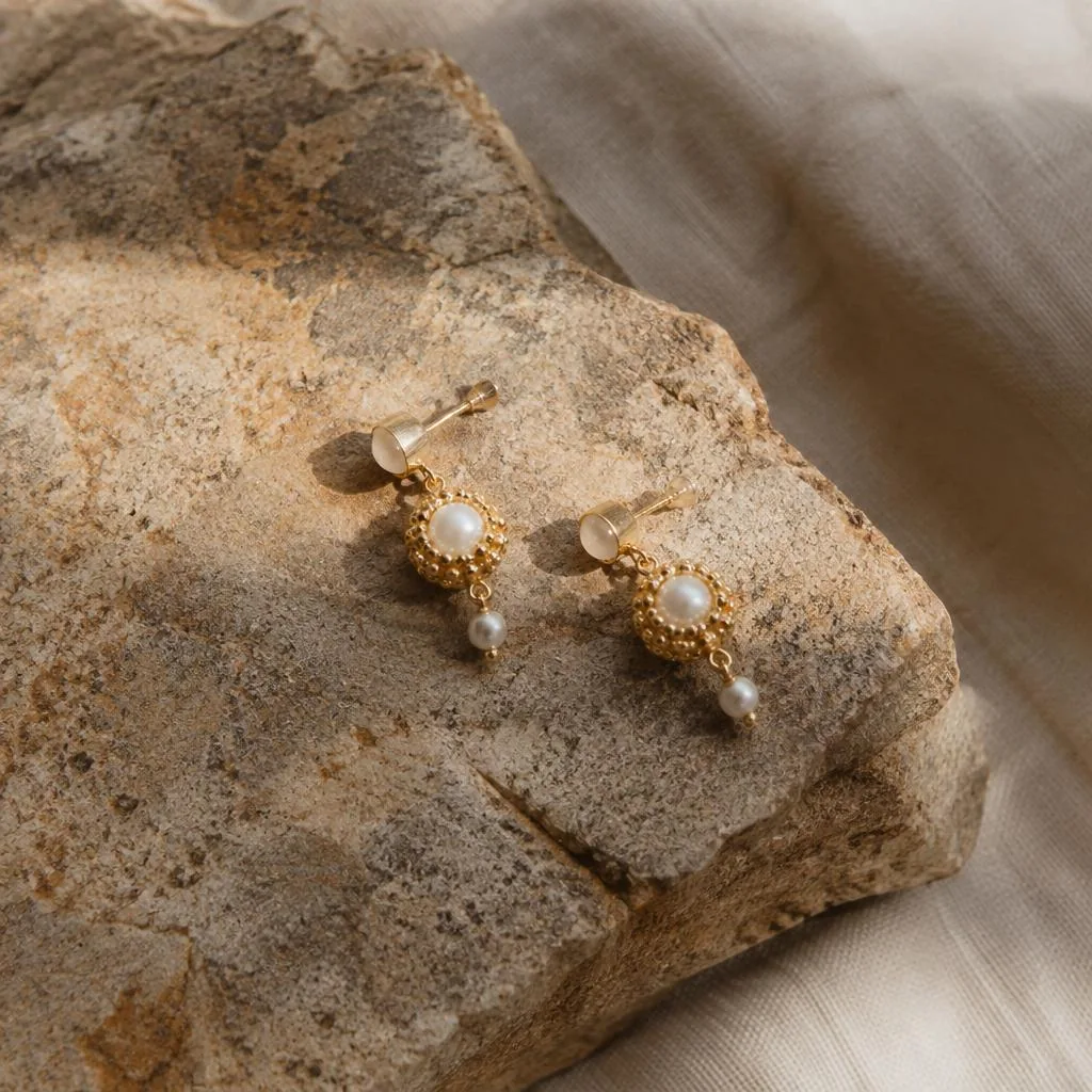 Pearl earrings with delicate gold-toned detailing